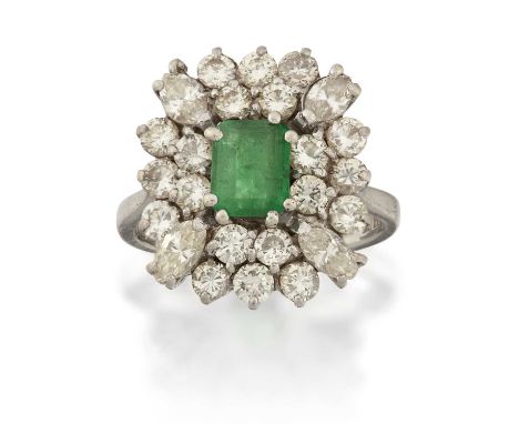 the emerald-cut emerald within a double stepped border of round brilliant cut diamonds, with marquise cut diamonds to the cor