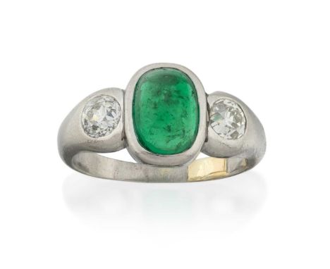 the cushion-shaped cabochon emerald flanked by old cut diamonds, in white rubbed over settings, to a plain polished shank, to