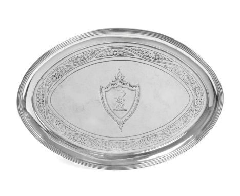 oval and on four tapering panel feet, with reeded rim, engraved with foliage centring a cartouche with an engraved crest18cm 