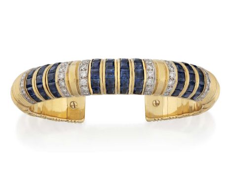 four rows of calibré cut sapphires in yellow channel settings, flanked by a row of round brilliant cut diamonds, in white pav