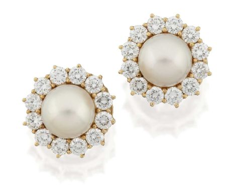 the cultured pearls within a border of round brilliant cut diamonds, in yellow claw settings, total estimated diamond weight 