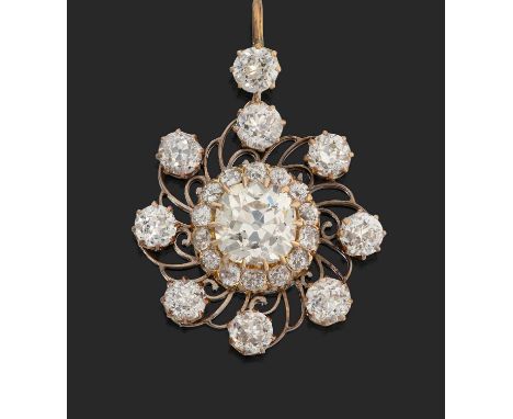 a cushion-shaped old cut diamond within a border of old cut diamonds, to an outer pierced and scrolled frame of further old c