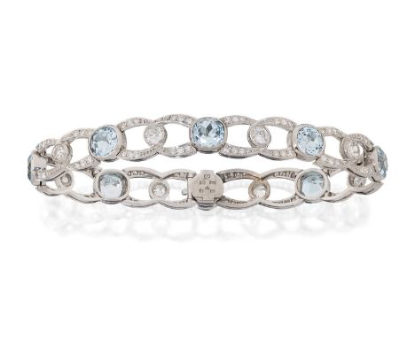 eight round cut blue topaz joined by eight-cut diamond set figure-of-eight links, with a larger old cut diamond centrally, in