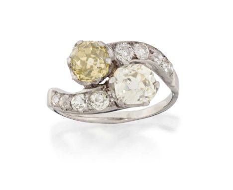 two old cut diamonds set diagonally, in white claw settings, to twist shoulders inset with old cut diamonds, to a plain polis