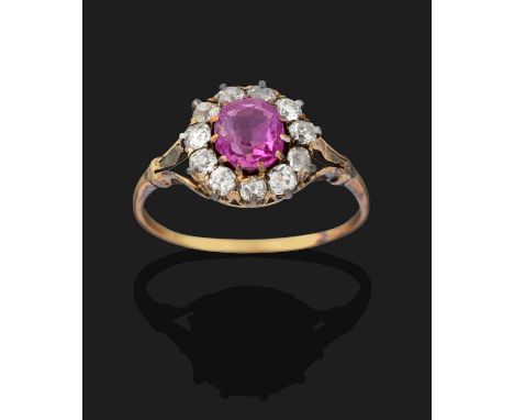 the round cut pink sapphire within a border of old cut diamonds, in white and yellow claw settings, to a yellow parted should