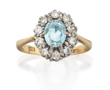 the oval cut aquamarine within a border of round brilliant cut diamonds, in white claw settings, to a yellow tapered shoulder