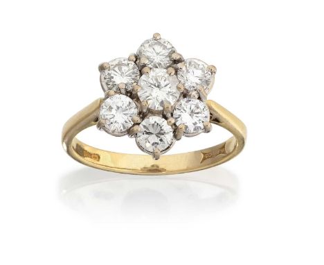 the central round brilliant cut diamond within a border of round brilliant cut diamonds, in white claw settings, to a yellow 
