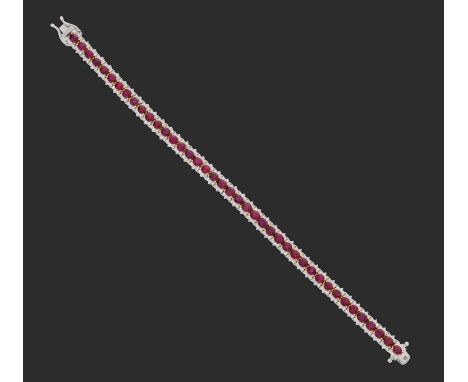 the forty-one oval cut rubies in yellow claw settings, flanked by trios of round brilliant cut diamonds, in white claw settin
