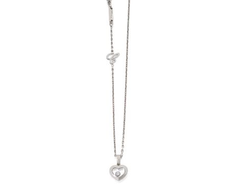the white plain polished heart-shaped frame with a single floating round brilliant cut diamond in a collet setting centrally,
