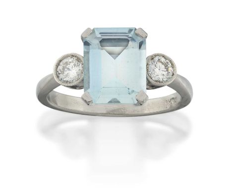 the emerald-cut aquamarine in a white claw setting, flanked by round brilliant cut diamonds in millegrain settings, to a tape