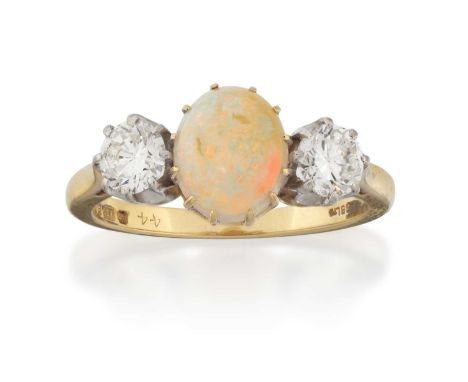 the oval cabochon opal in a yellow claw setting, flanked by round brilliant cut diamonds in white claw settings, to a yellow 
