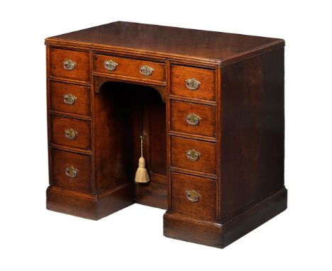 A GEORGE III OAK KNEEHOLE DESK OR DRESSING TABLE LATE 18TH CENTURYWith arrangement of four drawers to each pedestal, with dra