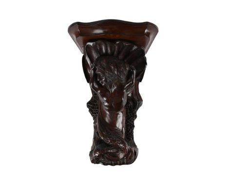 A CARVED MAHOGANY WALL BRACKET IN THE MEDIEVAL MANNER 19TH CENTURY  43 cm high, 25cm wide, 26cm deep  Condition Report:  PLEA