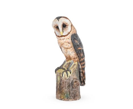 A PORCELAIN BARN OWL  SECOND HALF 20TH CENTURY  perched on a tree trunk 31cm high, 14cm wide, 11cm diameter at base  Conditio