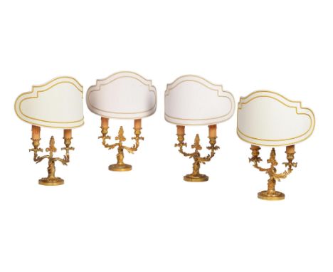 A GROUP OF FOUR TWO-LIGHT GILT METAL TABLE LAMPS  IN LOUIS XV ROCAILLE STYLE, 20TH CENTURY  two pairs, all with candle sleeve