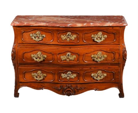A LOUIS XV PROVINCIAL WALNUT, GILT METAL MOUNTED, AND MARBLE TOPPED COMMODE  MID 18TH CENTURY 87cm high, 126cm wide, 54cm dee