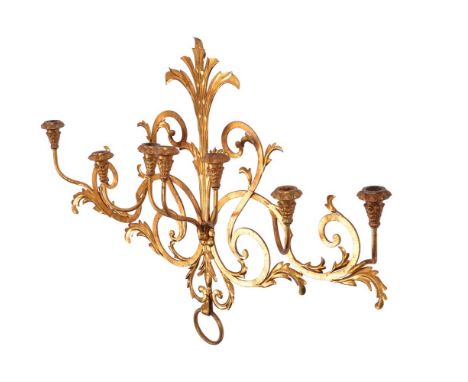 A GILT METAL SEVEN BRANCH WALL LIGHT PROBABLY FRENCH, 20TH CENTURY  72cm high, 130cm wide, 19cm protuberance    Provenance: P
