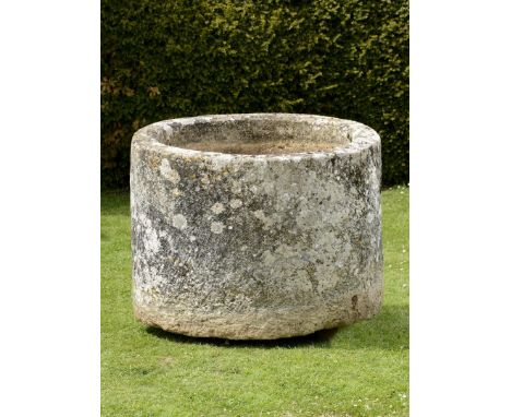 A large cylindrical carved limestone trough  81cm.; 32ins high by 115cm.; 45ins diameter