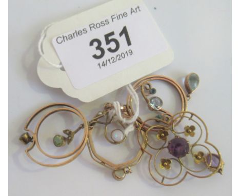 An amethyst set Edwardian pendant of opal petal work design, together with three further Edwardian circular pendants.