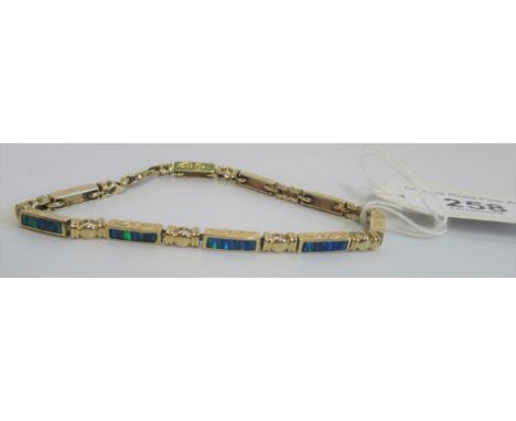 A 14 carat gold and black opal bracelet.