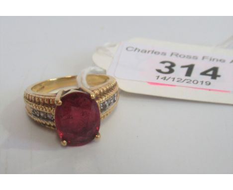 A single stone ruby ring, the oval cut ruby claw mounted above a diamond set 18 carat gold shoulders and shank, ring size 'O'