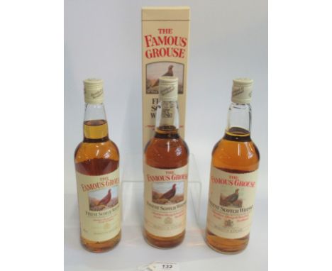 Three bottles of Famous Grouse Scotch Whisky.