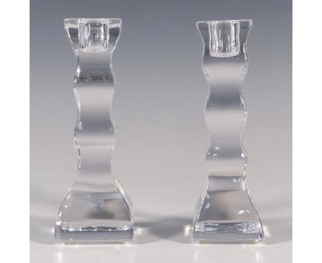 A set of two clear crystal candlestick holders with ripple columns. Orrefors marked. Artist: Helene KrantzIssued: c. 2000-201
