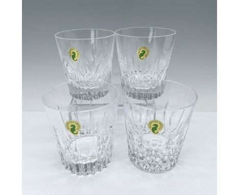 Set of four hand-cut crystal rocks glasses with distinctive patterns on each. Waterford etched backstamp. This item has its o