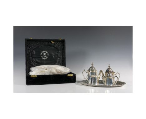 Lovely set comes with crimped oval tray, 2 tea pots with hinged lid, creamer and sugar bowl with lid. Velvet carrying case in