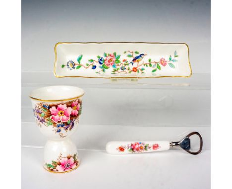 This grouping includes a double cup egg cup crafted from Melba, a ceramic handled bottle opener decorated with a floral patte