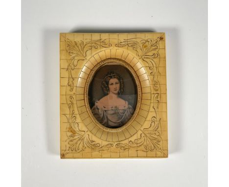 Housed in a carved acrylic frame, made to imitate bone. Features a colored print of the 19th century German actress, Charlott