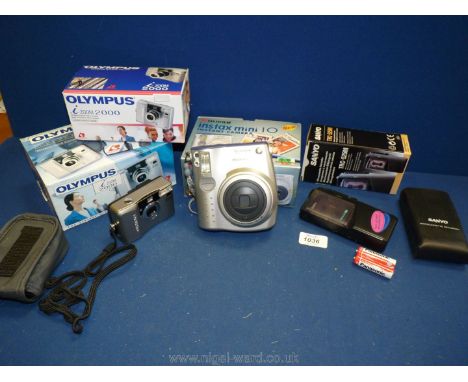 A Fujifilm instax mini 10 instant Camera lens 60mm, a boxed Olympus I Zoom 2000 digital camera, lens 25-50 mm and a Sanyo TRC