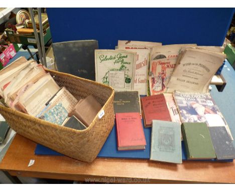 A Filing basket of vintage book and sheet music.