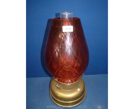 A large church oil heater/lamp on brass base with large glass cranberry shade, diamond pattern,18" tall in total.