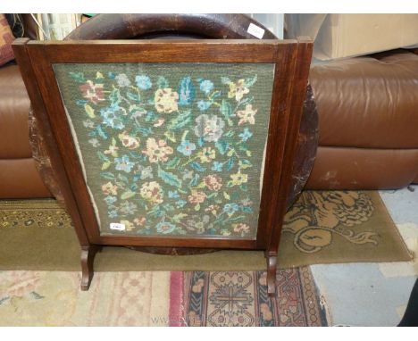 A floral tapestry Firescreen in an oak frame. 28" tall.