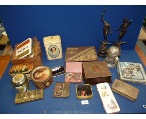 A box of vintage tins and a pair of cast figures a/f.