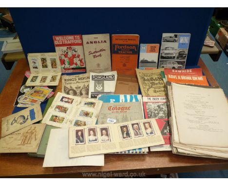 A box of ephemera including vintage car manuals, cigarette cards etc.