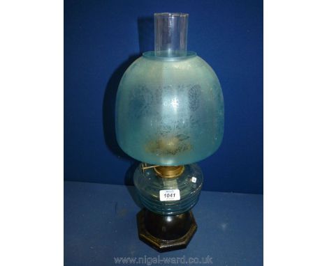 An Oil Lamp with sky blue domed shade decorated with butterflies and floral etchings, blue tinted reservoir and chimney, stan