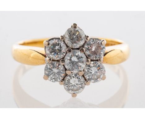 An 18ct gold diamond daisy ring, set with seven brilliant-cut diamonds, diamonds approx. 1.00 carat total, UK hallmark, size 
