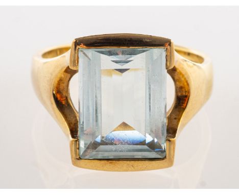 A 9ct gold aquamarine dress ring, semi-rubover set with a rectangular step-cut aquamarine, aquamarine approx. 5.40 carats, op