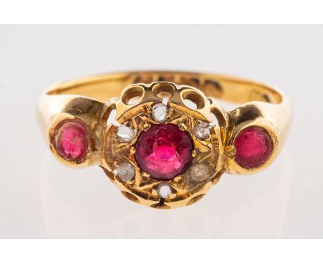 An 18ct gold antique ring, set with three circular-cut red paste stones, the centre red paste stone having a surround of smal