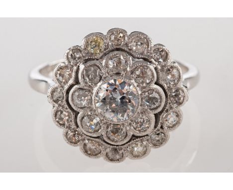 A diamond daisy halo ring, set with old-cut diamonds in the form of a flowerhead, diamonds approx. 0.65 carats total, marked 
