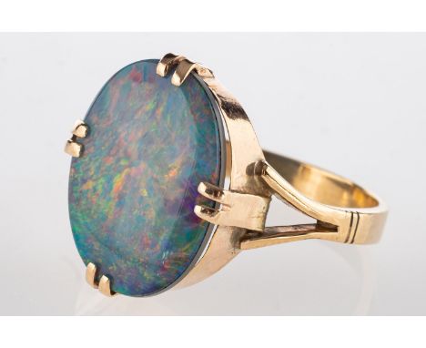 An opal doublet ring, double claw-set with an oval opal doublet, measuring approx. 17mm x 12mm, metal unmarked & untested, si