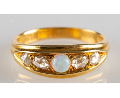 An 18ct gold early 20th Century opal and diamond ring, set with a circular-cut opal cabochon with two rose-cut diamonds set t