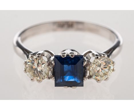 A sapphire and diamond three stone ring, set to the centre with a rectangular-cut sapphire, sapphire approx. 0.54 carat, with