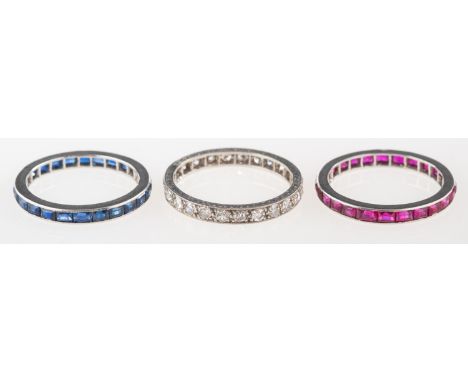 A group of three Art Deco eternity rings, including a full diamond eternity ring with engraved sides, milgrain & grain set wi