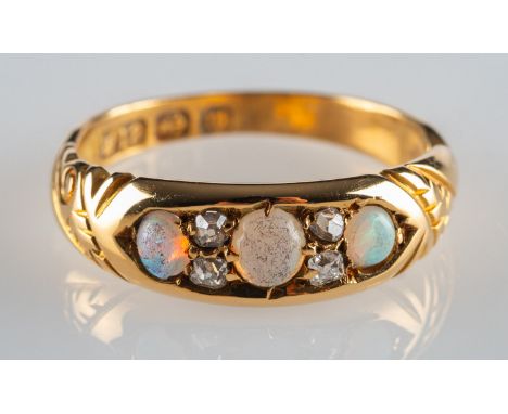 An 18ct gold antique opal and diamond ring, set with three opal cabochons, interspaced by four small old-cut diamonds, UK hal