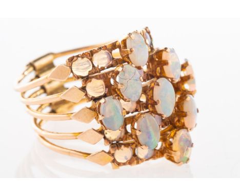 An opal stacking ring, made up of five bands each set with a mixture of circular-cut and oval-cut opal cabochons, the bands a