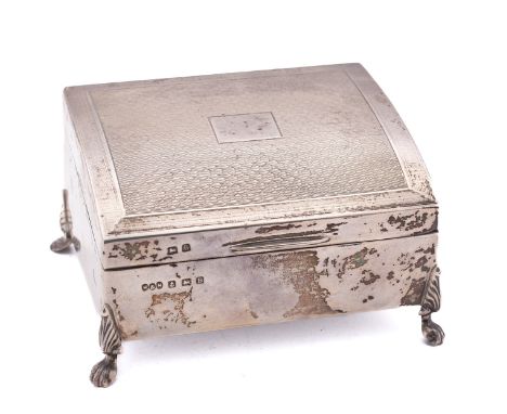 A George V silver cigarette casket by Hukin & Heath Ltd, Birmingham 1926, of bowed rectangular form, the hinged lid with engi