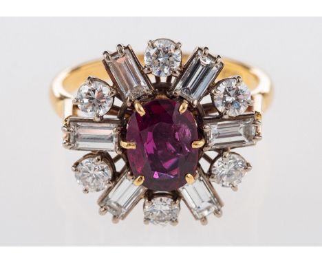 An 18ct gold ruby and diamond cluster ring, set centrally with an oval-cut ruby, ruby approx. 0.70 carat, surrounded by a mix